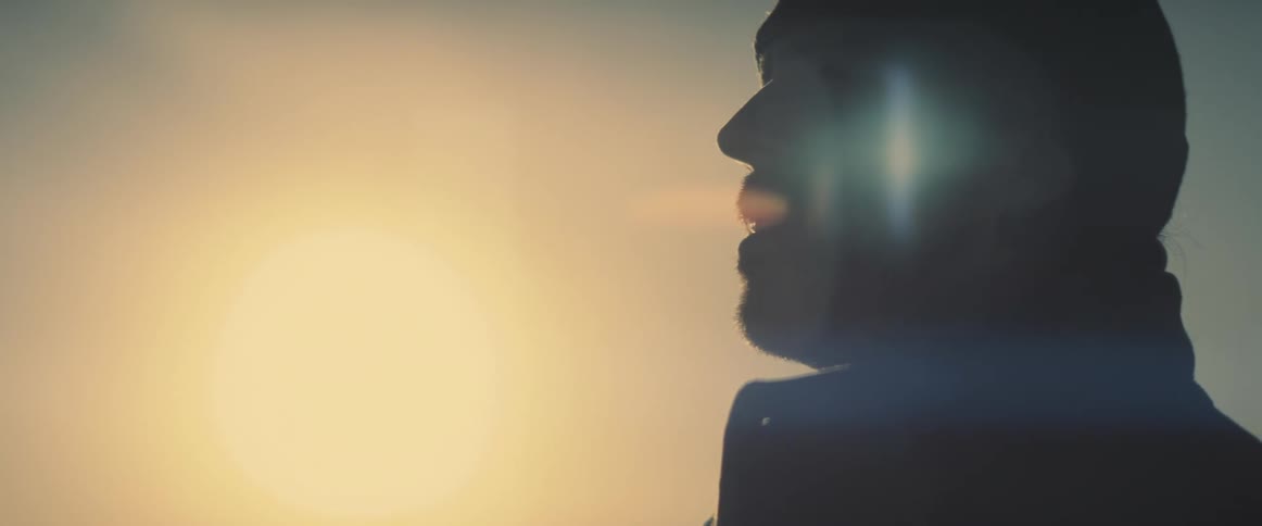 A man stands in dark and looks at a distance