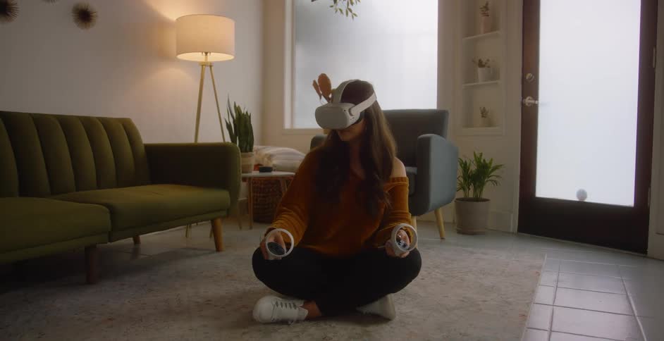 A woman sitting in a room using a vr headset