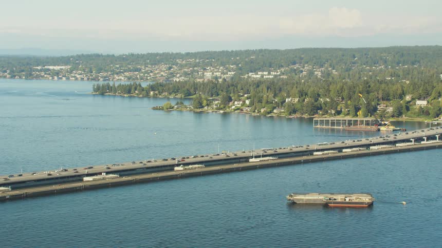 Cars are driving on a bridge over a body of water
