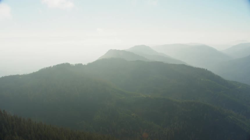 An aerial view of a mountain range on a foggy day