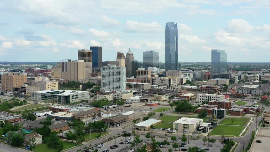 Several skyscrapers in the center of a city stand tall against the sky