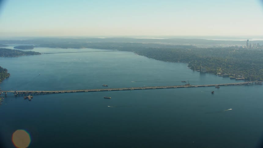 Traffic passes along a long bridge that goes in and out of downtown