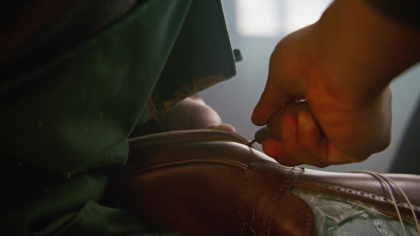 A man fixes a shoe