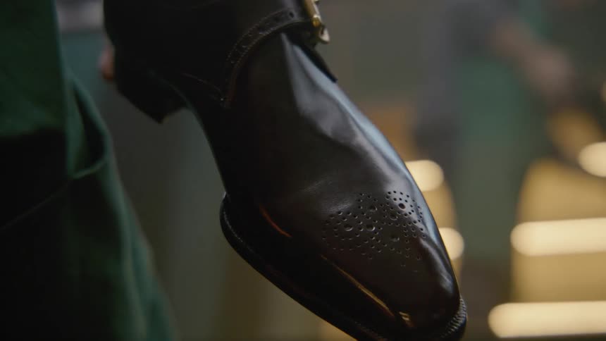 A person is cleaning a shoe with polish