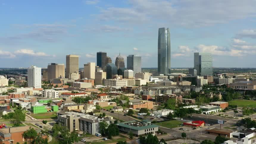 Tall skyscrapers downtown loom behind smaller neighborhood buildings