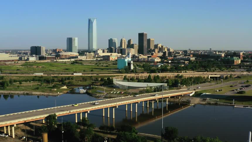 Aerial view of traffic flowing over bridges and roads near the city skyline