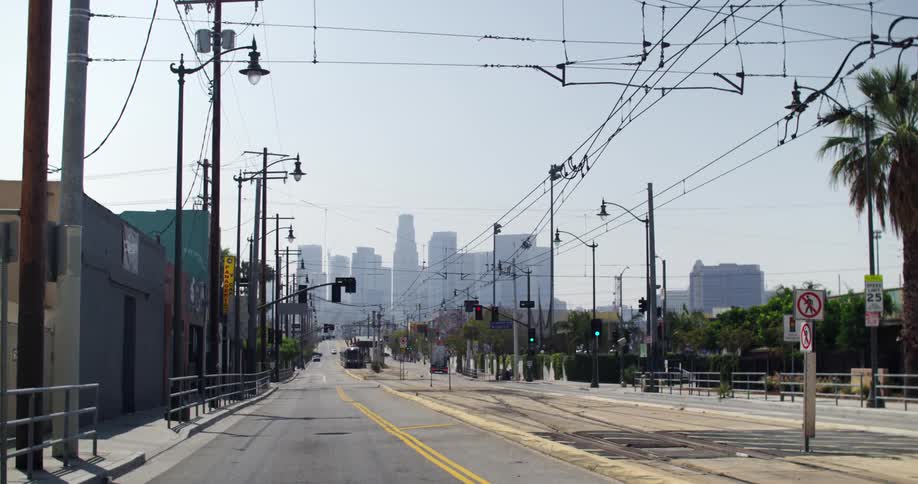 A city street has large buildings in the distance