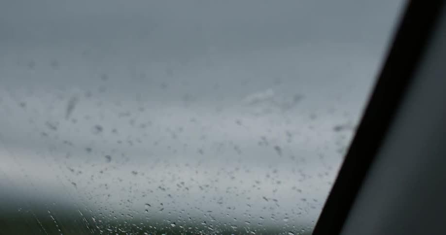 Raindrops on the windshield of a car in motion