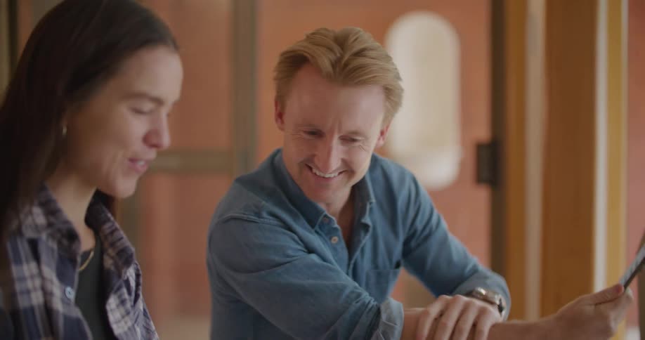 A woman shows a photo to a man