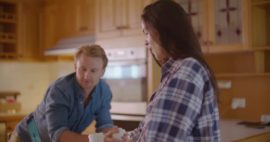 A man and woman looking at a laptop