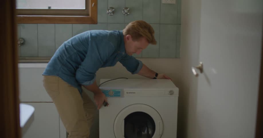 Couple cleaning and moving appliances at home