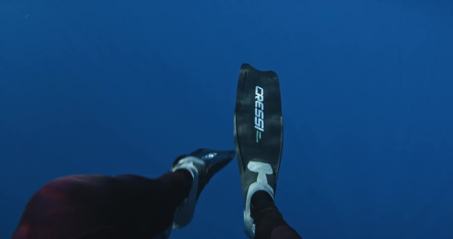 A man flaps his diving slippers below