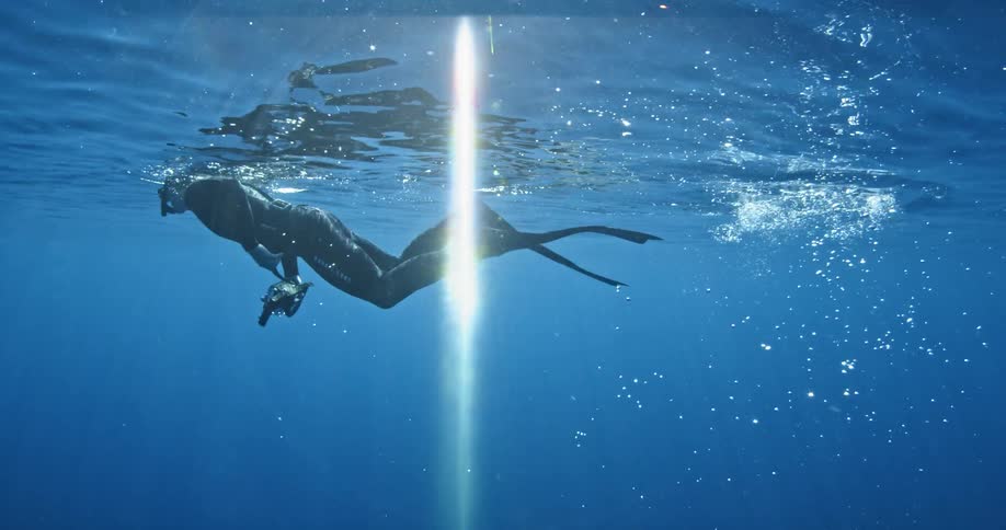 Scuba diver swimming just below the surface of the water