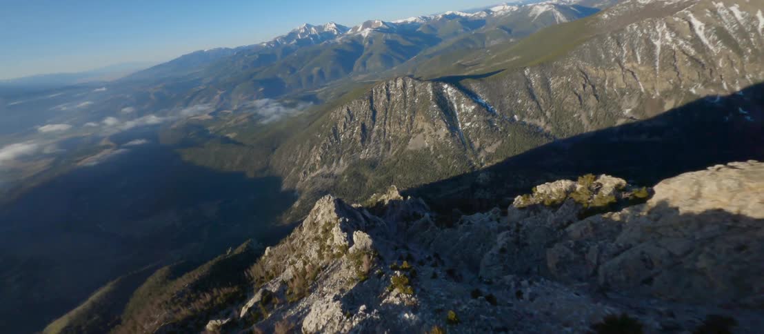 A mountain range slope with plants gravel and rocks