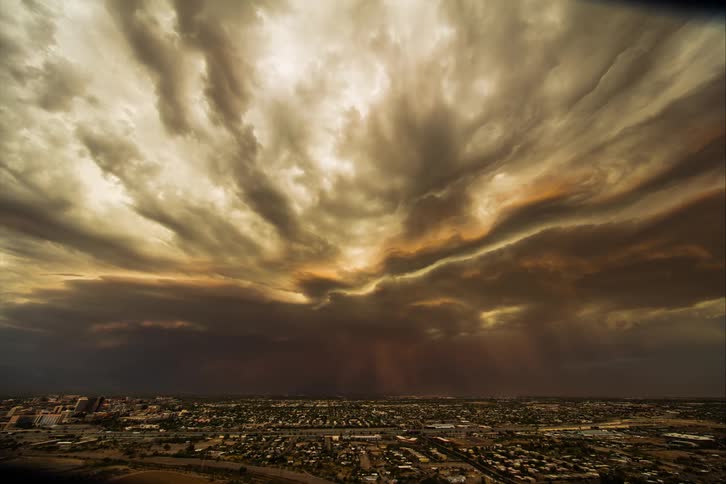 Traffic moves through city as storm front moves across horizon