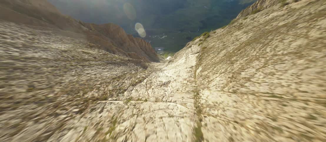 A mountain range slope with plants gravel and rocks