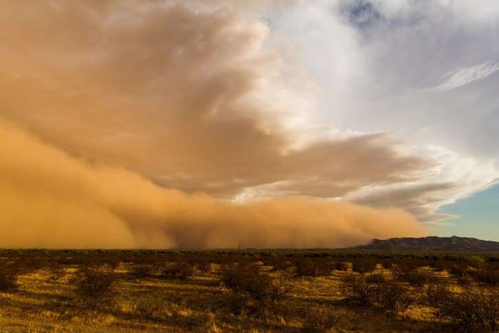 Time lapse of a sand storm rolling over the badlands at daytime