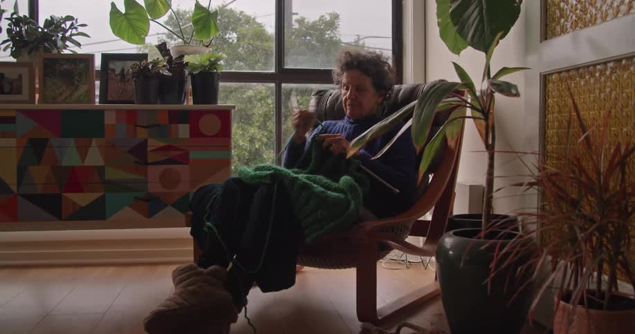 A woman knitting in a room