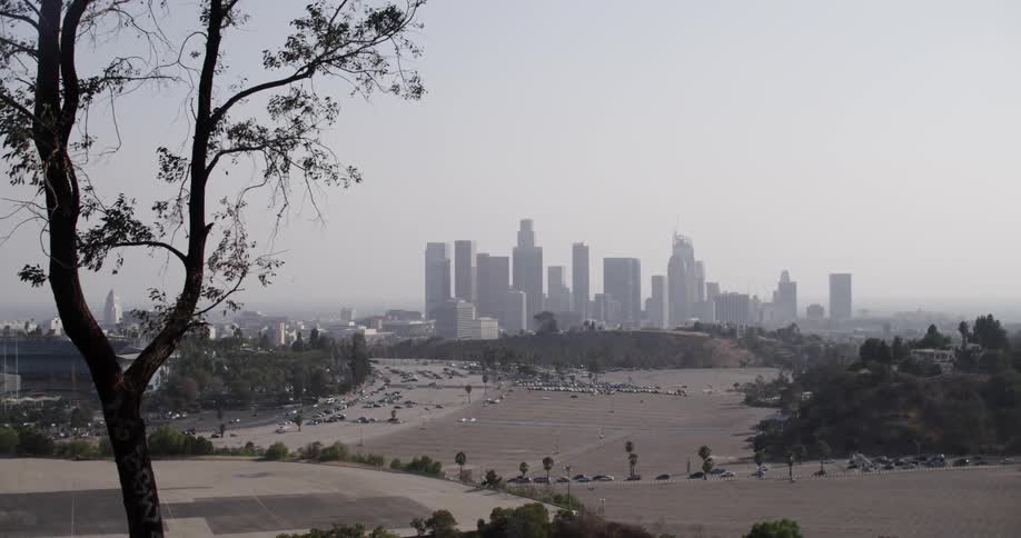 A city sits in the distance on a cloudy day