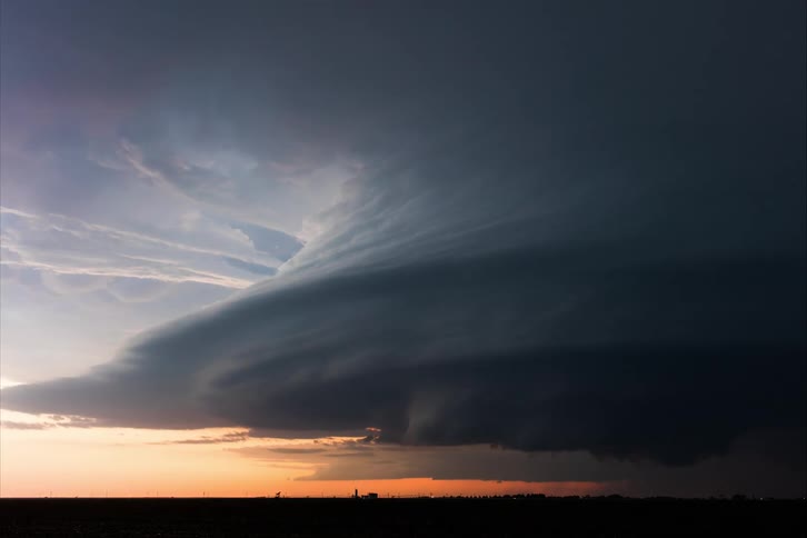 Lightning flashes as an enormous tornado is building strength up in the sky