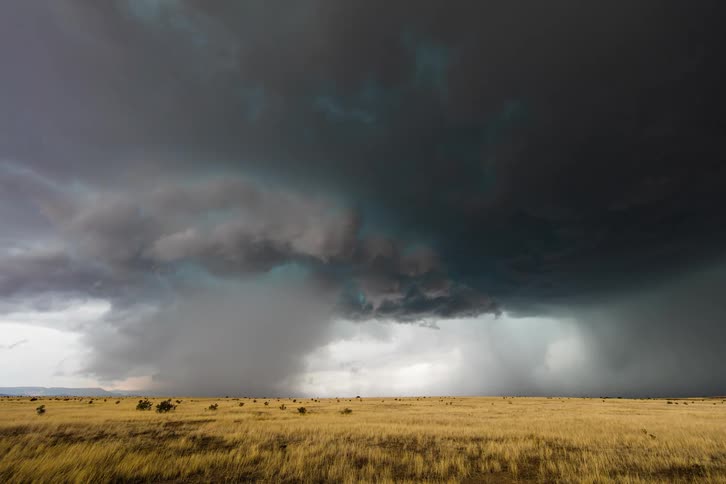 Landscape view of storm clouds over a field