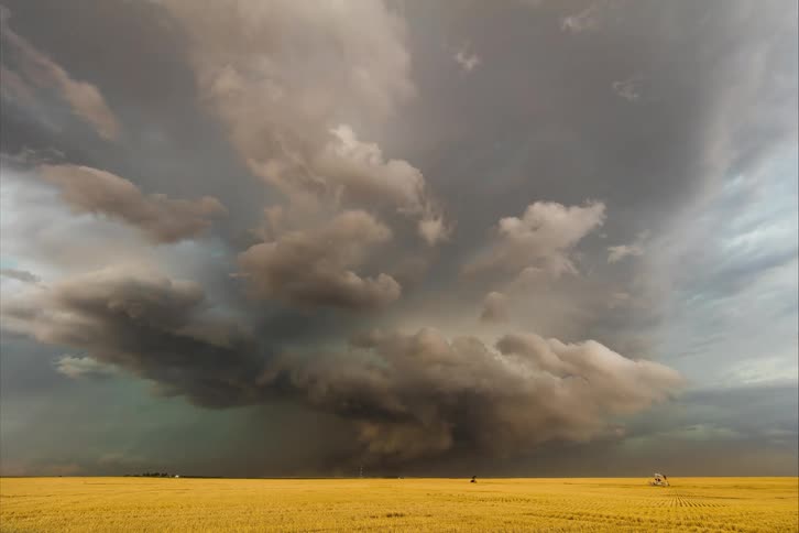 Tornado clouds move in rotation as lightning flashes