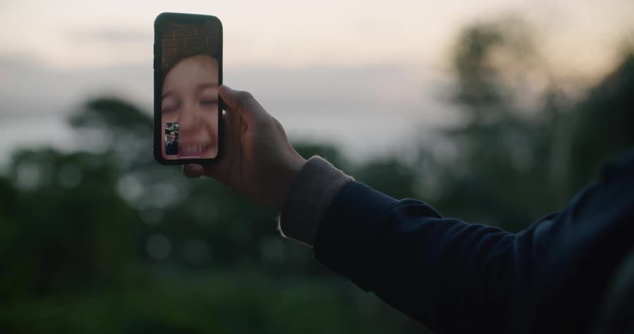 A person is talking with a child on video phone