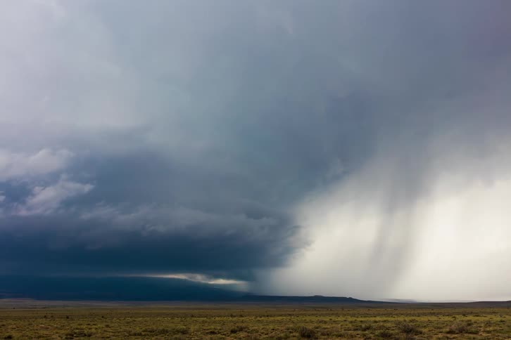 Storm clouds are in rotation above the ground