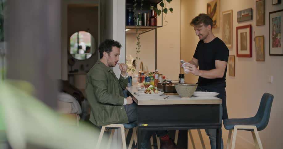 Two young man serving lunch at home