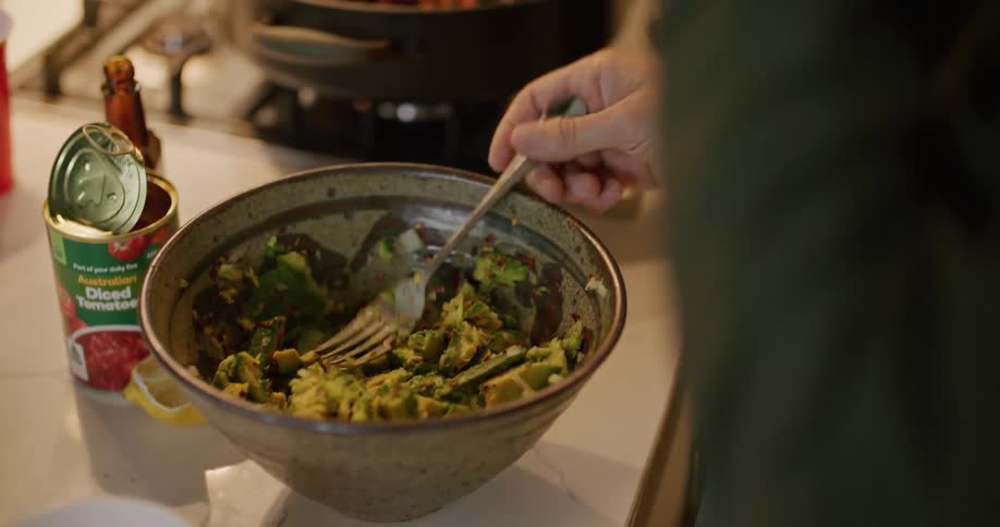Two men cook and stir food in the pan in the kitchen