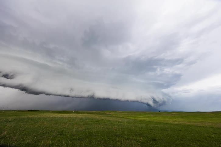 Pale gray storm clouds flow across plains