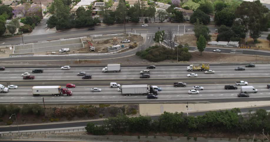 Cars and trucks move on a highway below