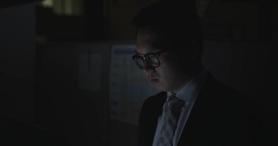 An employee is working in the office at night