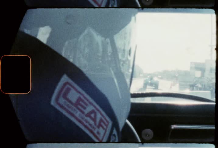 A person in a race car drives to the starting line