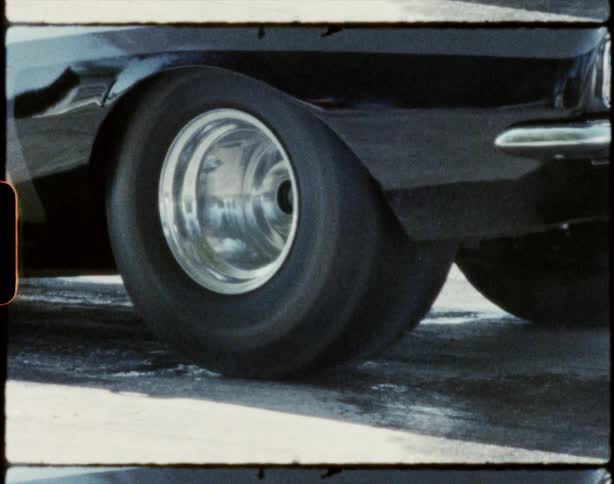 Smoke coming off of a race cars tire as it spins