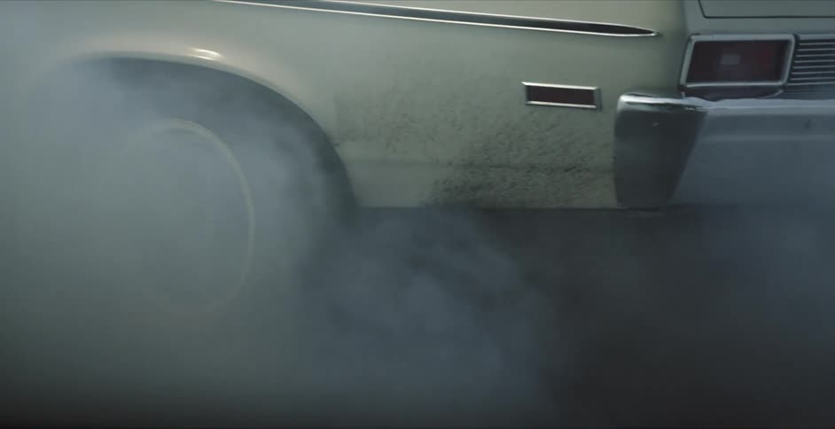 Car tires spin burning rubber and causing smoke to billow