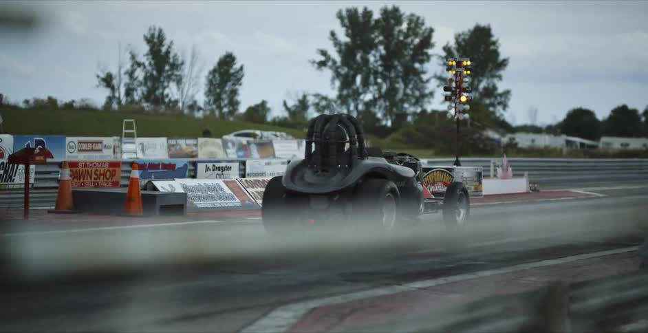 Two race cars on a track take off