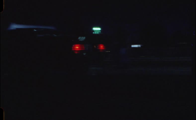 A sports car driving by at night