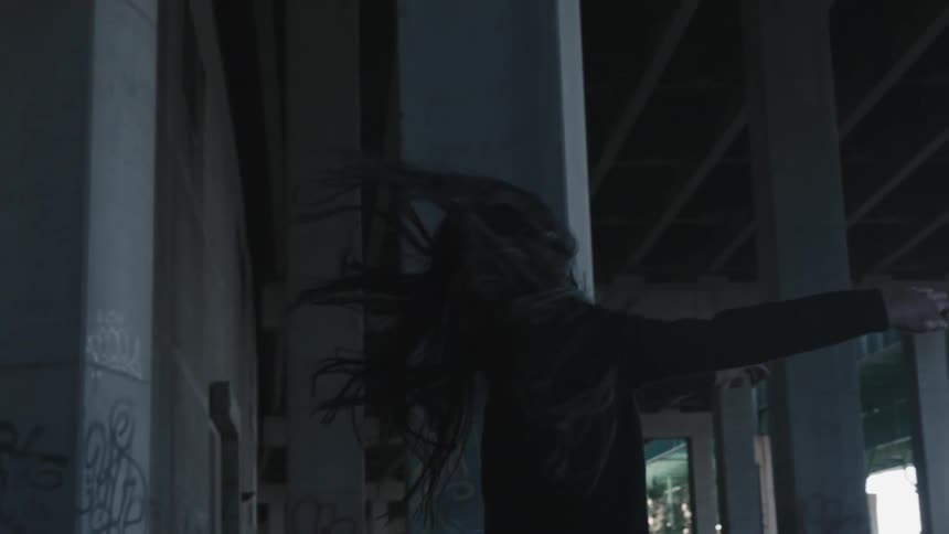 Slow motion of a woman dancing outdoors