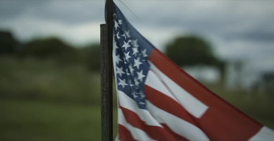 American flag waving in the wind on a field