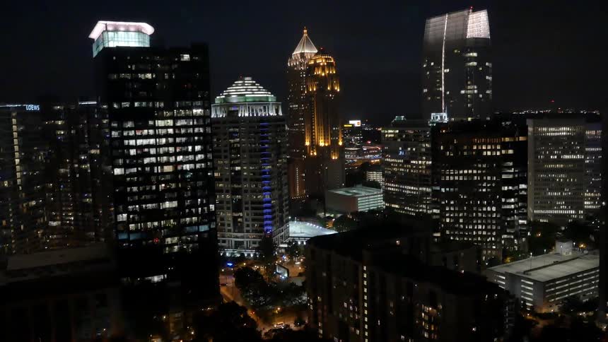 Large city buildings are lit up at night