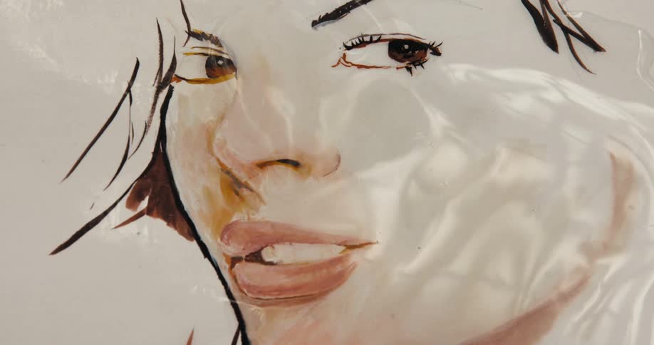 Translucent glimmering fluid effect moves over surface of artwork of womans face