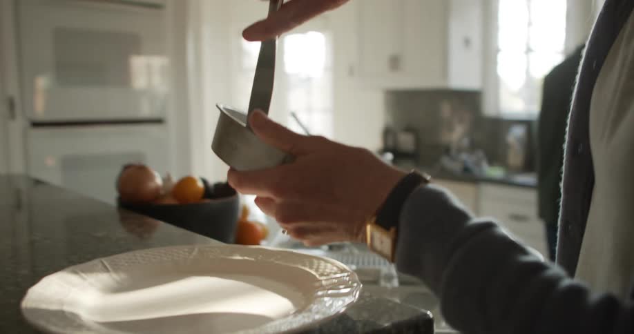 A woman puts a cake on the platter