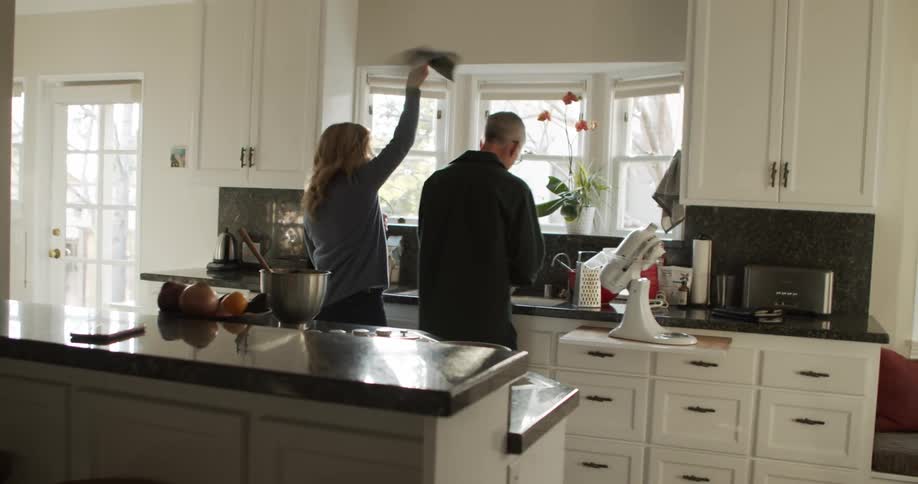 A man and woman cooking in the kitchen