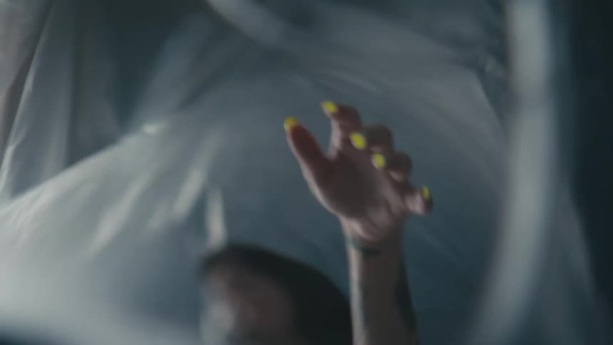 A woman dancing in a piece of plastic