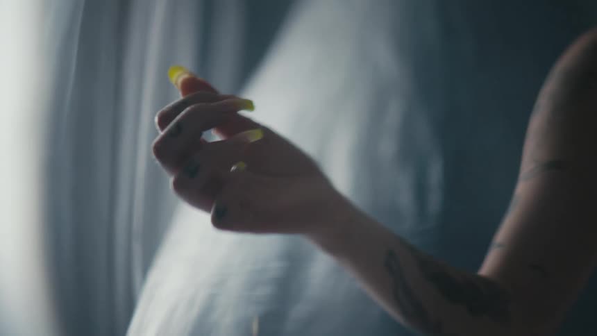Nail polish is dripping from the persons fingers