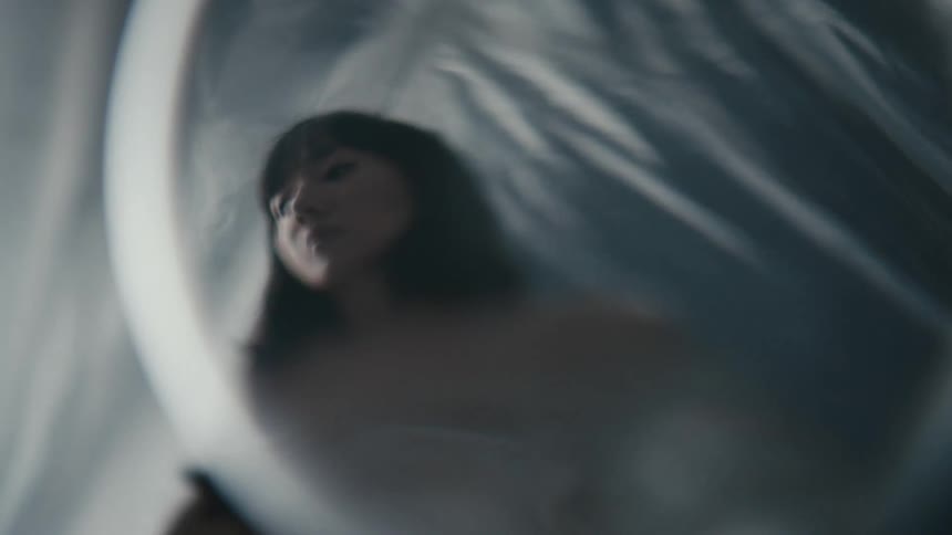 A dancer putting plastic over her face
