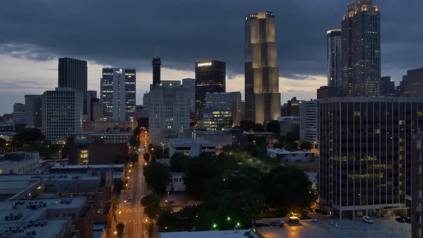 Aerial view of lit buildings in a city