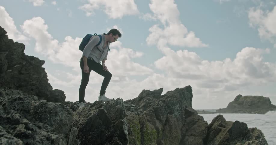 A man standing out near the ocean