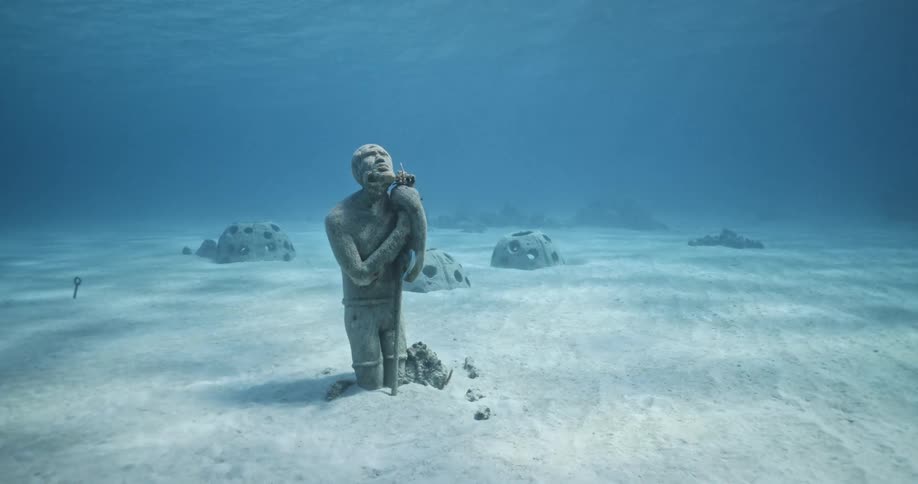A statue of a man is underwater